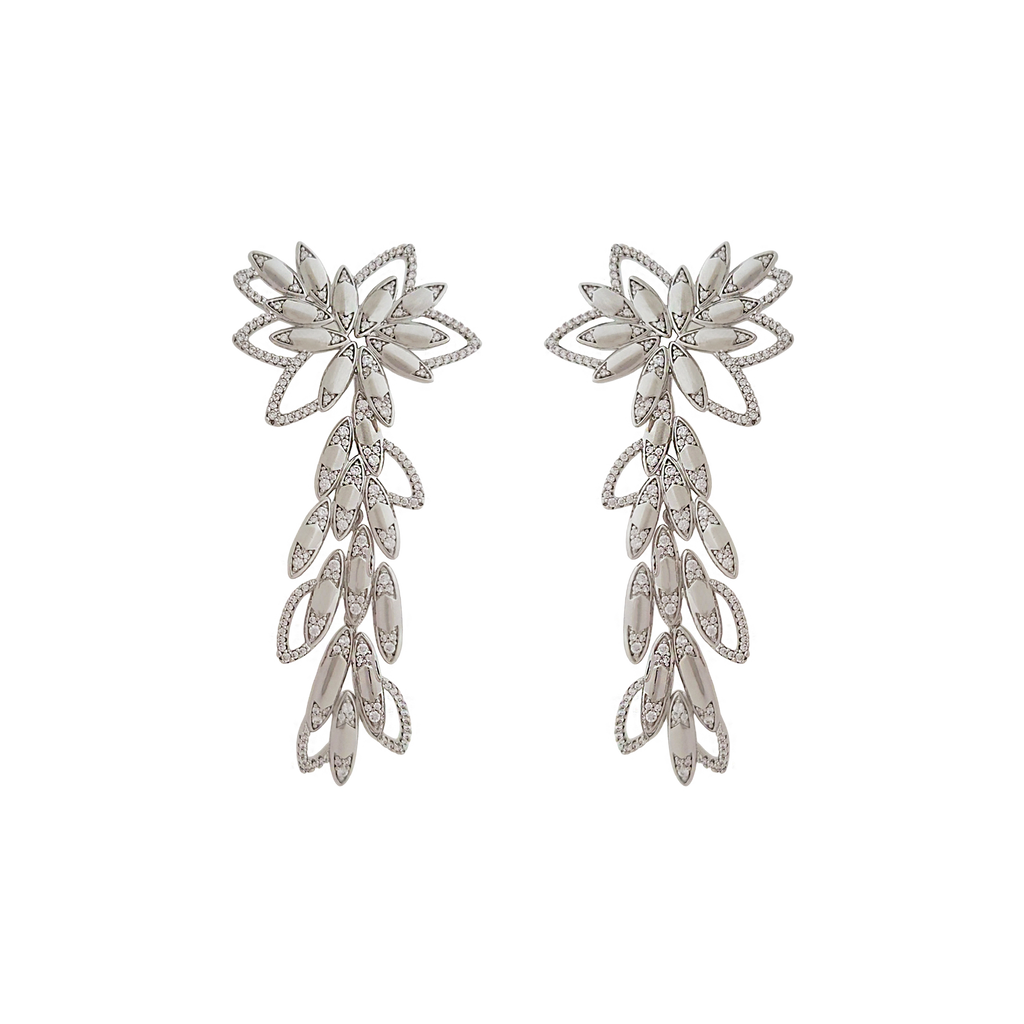 Statement Earrings in Rhodium plated brass by Mcristals. Flower design with a drop making it a dangle earring full of details in cubic zirconias.