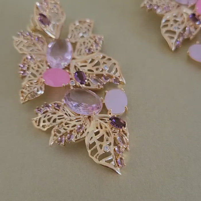 Close up video showing earrings details. 18k Gold plated statement earrings. Organic Leaf design with pink and purple crystals and cubic zirconias by Mcristals 